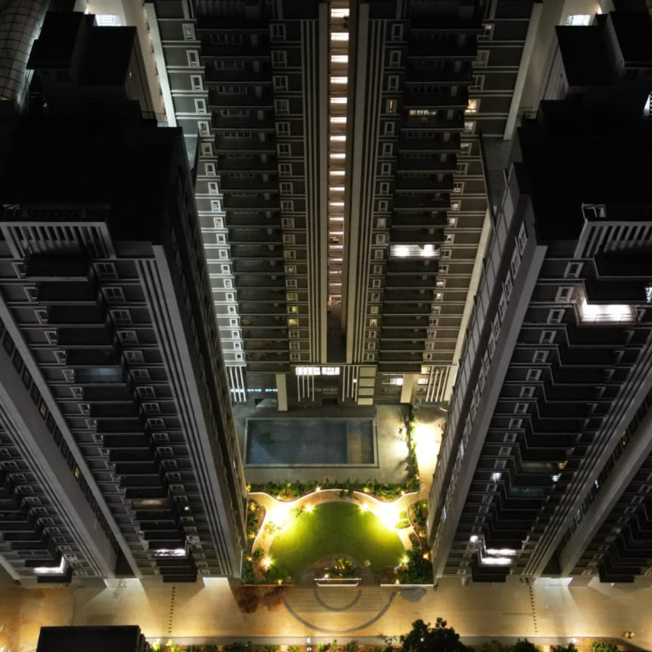 Tamra Asteria tower at dusk above its landscaped podium
